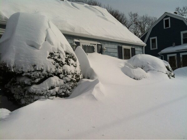 Blue house with snow covering the front door
